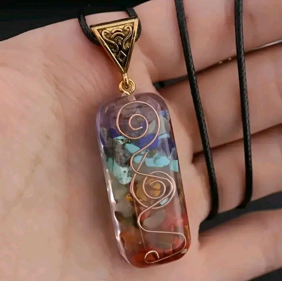 7 Chakra Reiki Stone pendant with vibrant fused crystals for meditation and healing.