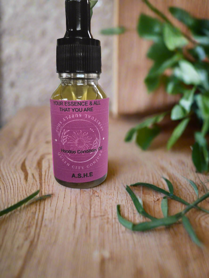 Ashè Hoodoo Conjure Oil bottle for spiritual empowerment and rituals on wooden surface.