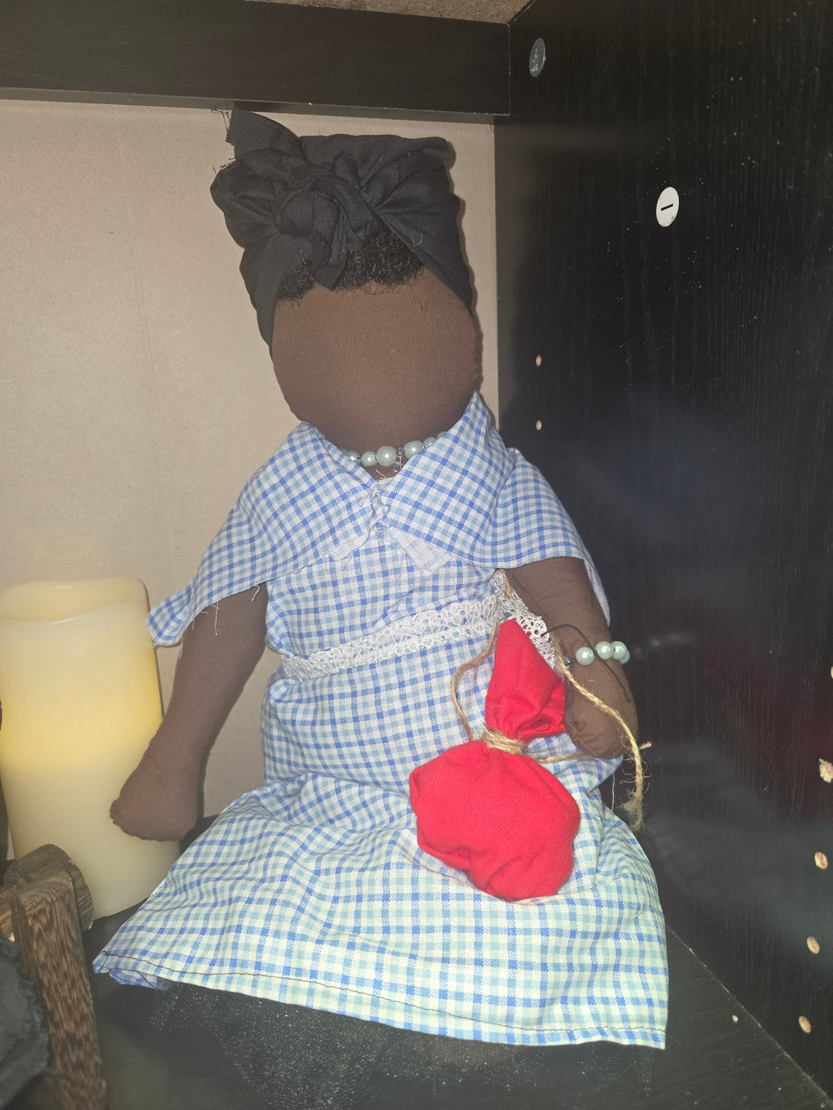 Big Mama ancestor doll representing someone who needs support, focusing on their well-being.