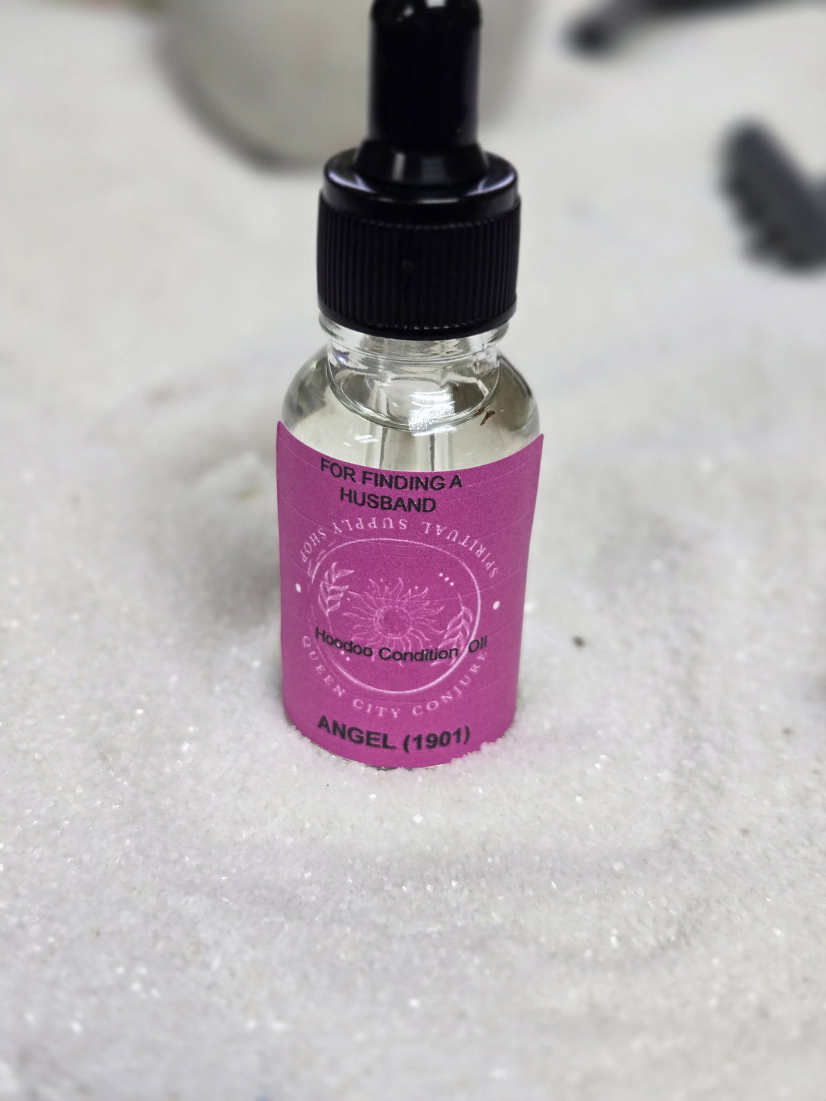 Bottle of 1901 Angel Oil for finding a husband with dropper hoodoo condition on white background