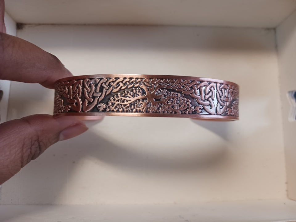 Adjustable copper magnetic cuff bangle with detailed Tree of Life design symbolizing growth and strength