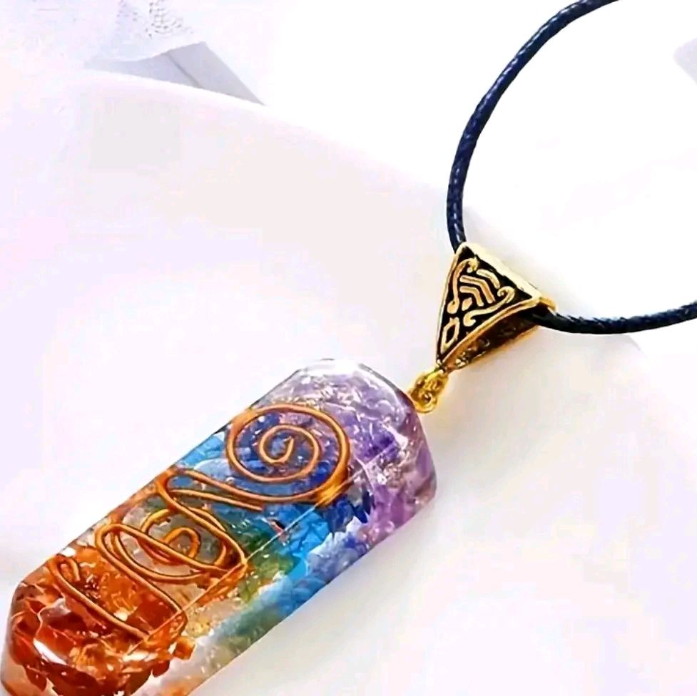 7 Chakra Reiki Stone pendant with vibrant crystals on a black cord.